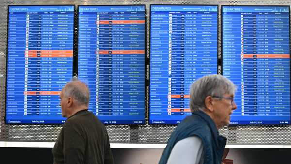 Departure monitors show canceled and delayed flights at Ronald Reagan Washington National Airport on July 19, 2024, in Arlington, Virginia, during a major worldwide computer systems outage. The outage has wrought havoc on computer systems worldwide, grounding flights across the globe, including in Europe and the US, derailing television broadcasts in the UK and impacting telecommunications in Australia. US carriers Delta and United Airlines grounded all their flights earlier on July 19 over communication issues, the Federal Aviation Administration said. (Photo by Mandel NGAN / AFP) (Photo by MANDEL NGAN/AFP via Getty Images)