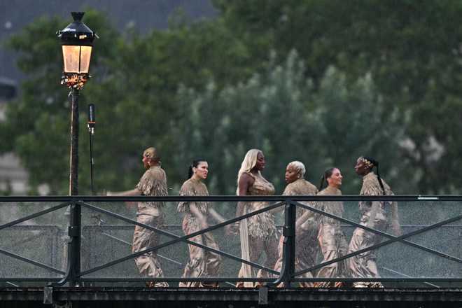 TOPSHOT&#x20;-&#x20;Singer&#x20;Aya&#x20;Nakamura&#x20;&#x28;C&#x29;&#x20;and&#x20;dancers&#x20;perfom&#x20;on&#x20;the&#x20;Pont&#x20;des&#x20;Arts&#x20;footbridge&#x20;during&#x20;the&#x20;opening&#x20;ceremony&#x20;of&#x20;the&#x20;Paris&#x20;2024&#x20;Olympic&#x20;Games&#x20;in&#x20;Paris&#x20;on&#x20;July&#x20;26,&#x20;2024.&#x20;&#x28;Photo&#x20;by&#x20;Gabriel&#x20;BOUYS&#x20;&#x2F;&#x20;AFP&#x29;&#x20;&#x28;Photo&#x20;by&#x20;GABRIEL&#x20;BOUYS&#x2F;AFP&#x20;via&#x20;Getty&#x20;Images&#x29;