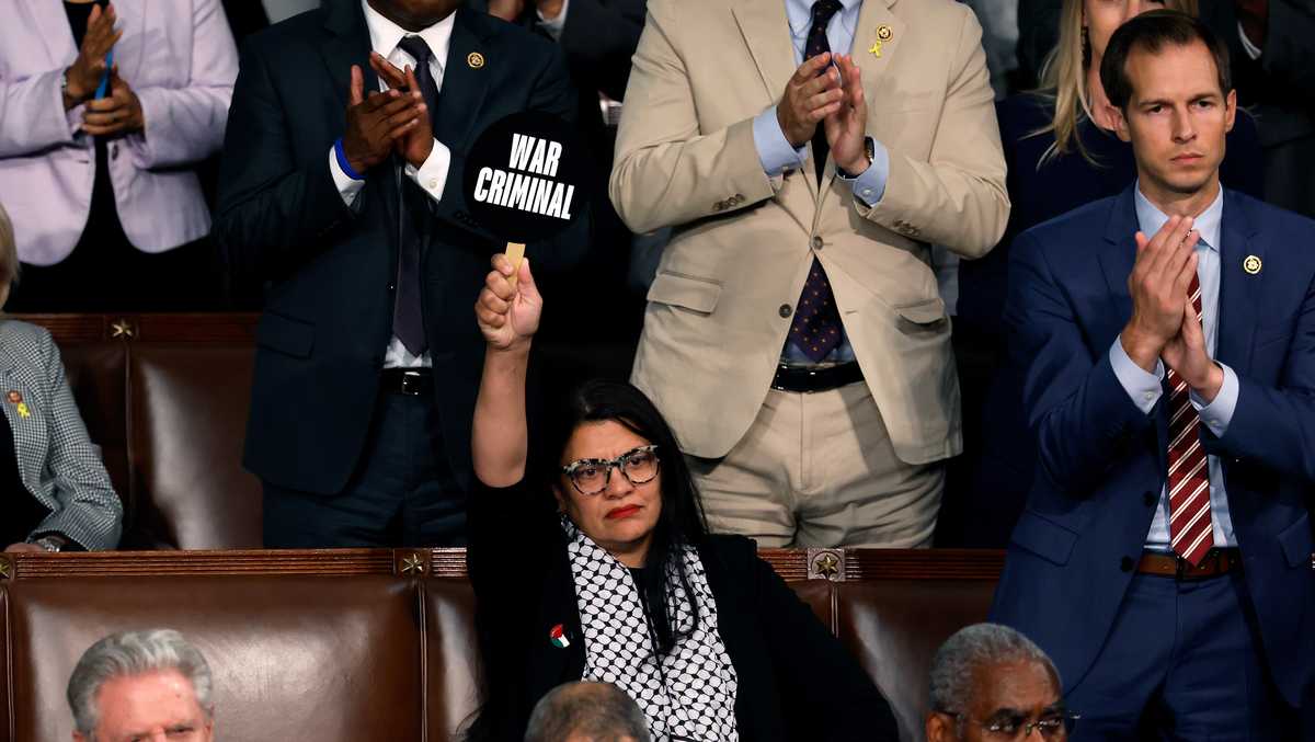 Rep. Rashida Tlaib holds up 'war criminal' sign during Netanyahu address