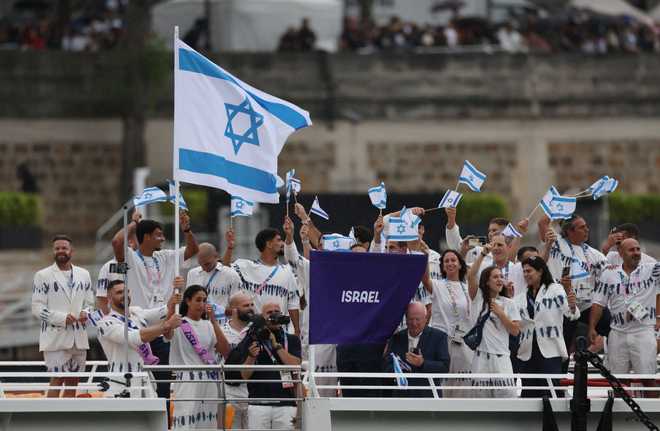 PARIS,&#x20;FRANCE&#x20;-&#x20;JULY&#x20;26&#x3A;&#x20;Team&#x20;Israel&#x20;flagbearers&#x20;Andrea&#x20;Murez&#x20;and&#x20;Peter&#x20;Paltchik&#x20;are&#x20;seen&#x20;with&#x20;their&#x20;team&#x20;traveling&#x20;down&#x20;the&#x20;River&#x20;Seine&#x20;during&#x20;the&#x20;opening&#x20;ceremony&#x20;of&#x20;the&#x20;Olympic&#x20;Games&#x20;Paris&#x20;2024&#x20;on&#x20;July&#x20;26,&#x20;2024&#x20;in&#x20;Paris,&#x20;France.&#x20;&#x28;Photo&#x20;by&#x20;Maja&#x20;Hitij&#x2F;Getty&#x20;Images&#x29;
