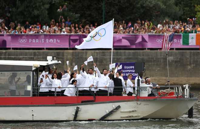 PARIS,&#x20;FRANCE&#x20;-&#x20;JULY&#x20;26&#x3A;&#x20;Refugee&#x20;Olympic&#x00A0;Team&#x20;are&#x20;seen&#x20;on&#x20;a&#x20;boat&#x20;on&#x20;the&#x20;River&#x20;Seine&#x20;during&#x20;the&#x20;opening&#x20;ceremony&#x20;of&#x20;the&#x20;Olympic&#x20;Games&#x20;Paris&#x20;2024&#x20;on&#x20;July&#x20;26,&#x20;2024&#x20;in&#x20;Paris,&#x20;France.&#x20;&#x28;Photo&#x20;by&#x20;Kevin&#x20;C.&#x20;Cox&#x2F;Getty&#x20;Images&#x29;