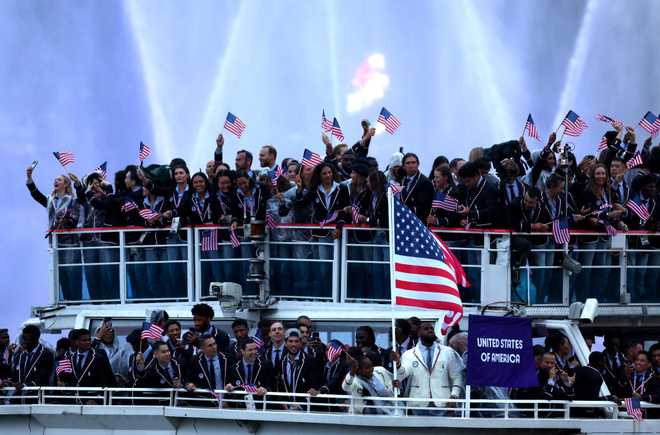 PARIS,&#x20;FRANCE&#x20;-&#x20;JULY&#x20;26&#x3A;&#x20;Lebron&#x20;James,&#x20;Flagbearer&#x20;of&#x20;Team&#x20;United&#x20;States,&#x20;waves&#x20;the&#x20;American&#x20;flag&#x20;while&#x20;cruising&#x20;on&#x20;the&#x20;River&#x20;Seine&#x20;during&#x20;the&#x20;athletes&#x2019;&#x20;parade&#x20;during&#x20;the&#x20;opening&#x20;ceremony&#x20;of&#x20;the&#x20;Olympic&#x20;Games&#x20;Paris&#x20;2024&#x20;on&#x20;July&#x20;26,&#x20;2024&#x20;in&#x20;Paris,&#x20;France.&#x20;&#x28;Photo&#x20;by&#x20;Maja&#x20;Hitij&#x2F;Getty&#x20;Images&#x29;