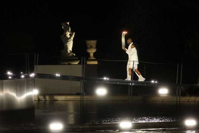 PARIS,&#x20;FRANCE&#x20;-&#x20;JULY&#x20;26&#x3A;&#x20;Torch&#x20;bearers&#x20;French&#x20;Athlete&#x20;Marie-Jose&#x20;Perec&#x20;and&#x20;French&#x20;Judo&#x20;Practitioner&#x20;Teddy&#x20;Riner&#x20;light&#x20;the&#x20;Olympic&#x20;Cauldron&#x20;at&#x20;the&#x20;Gardens&#x20;of&#x20;the&#x20;Tuileries&#x20;during&#x20;the&#x20;opening&#x20;ceremony&#x20;of&#x20;the&#x20;Olympic&#x20;Games&#x20;Paris&#x20;2024&#x20;on&#x20;July&#x20;26,&#x20;2024&#x20;in&#x20;Paris,&#x20;France.&#x20;&#x28;Photo&#x20;by&#x20;Carmen&#x20;Mandato&#x2F;Getty&#x20;Images&#x29;