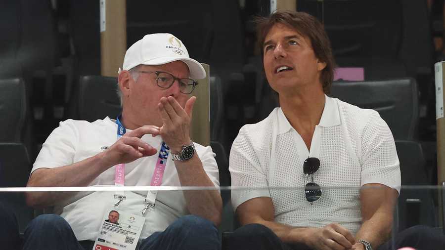 PARIS, FRANCE - JULY 28: Tom Cruise (R) speaks with David Zaslav as they attend the Artistic Gymnastics Women's Qualification on day two of the Olympic Games Paris 2024 at Bercy Arena on July 28, 2024 in Paris, France. (Photo by Jamie Squire/Getty Images)