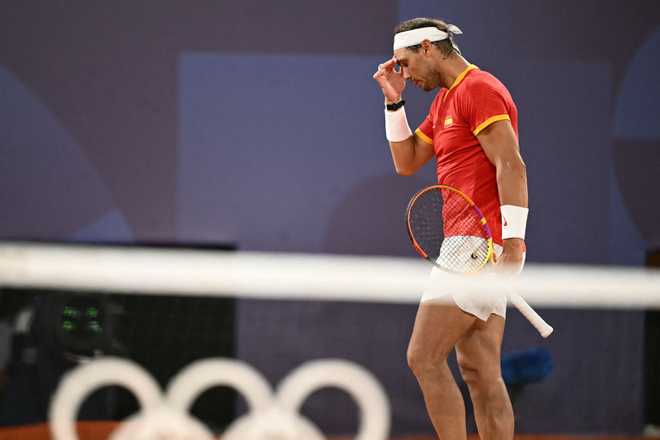 Spain&apos;s Rafael Nadal reacts playing with Spain&apos;s Carlos Alcaraz against US&apos; Austin Krajicek and US&apos; Rajeev Ram during their men&apos;s doubles quarter-final tennis match on Court Philippe-Chatrier at the Roland-Garros Stadium during the Paris 2024 Olympic Games, in Paris on July 31, 2024. (Photo by CARL DE SOUZA / AFP) (Photo by CARL DE SOUZA/AFP via Getty Images)