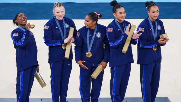 PARIS, FRANCE - JULY 30: Simone Biles celebrates with Team United States teammates and Gold medalists on the podium during the medal ceremony for the Artistic Gymnastics Women's Team Final on day four of the Olympic Games Paris 2024 at Bercy Arena on July 30, 2024 in Paris, France. (Photo by Patrick Smith/Getty Images)