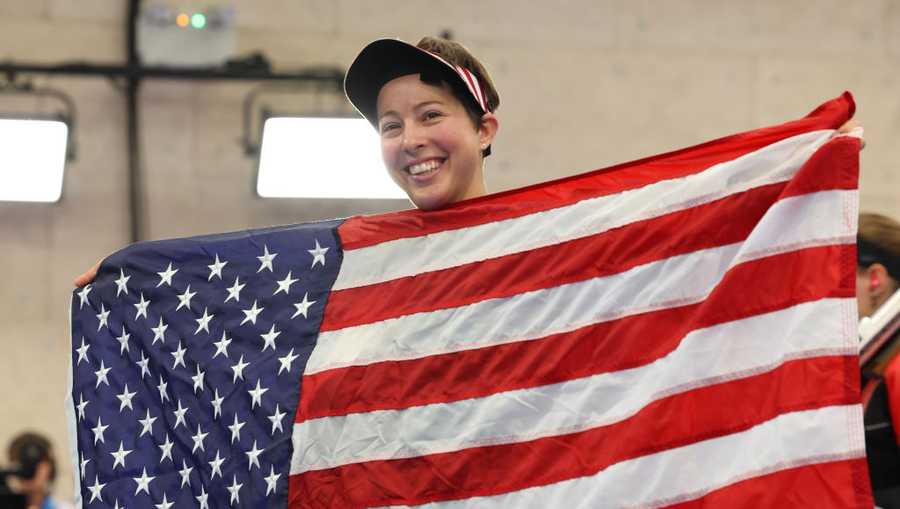 CHATEAUROUX, FRANCE - AUGUST 02: Silver medalist Sagen Maddalena of Team United States celebrates with a Team United States flag following the Women&apos;s 50m Rifle 3 Positions Final on day seven of the Olympic Games Paris 2024 at Chateauroux Shooting Centre on August 02, 2024 in Chateauroux, France. (Photo by Charles McQuillan/Getty Images)