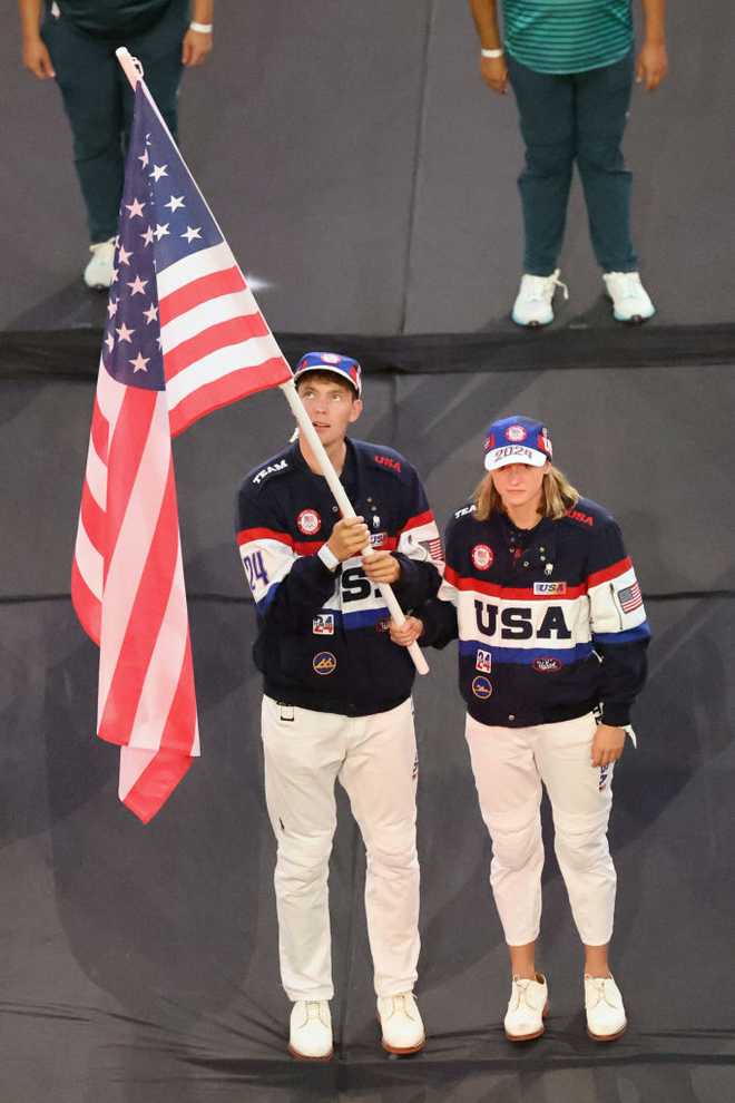 PARIS, FRANCE - AUGUST 11: Flagbearers Nick Mead and Katie Ledecky of Team United States of America hold their nation&apos;s flag during the Closing Ceremony of the Olympic Games Paris 2024 at Stade de France on August 11, 2024 in Paris, France. (Photo by Arturo Holmes/Getty Images)