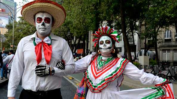 A couple dressed as a Catrina take part in the Procession of Catrinas ahead of the Day of the Dead at Reforma Avenue in Mexico City on October 27, 2024. On November 2, Mexico celebrates the 'Dia de los Muertos' (Day of the Dead) to pay respects to friends and family members who have died. (Photo by ROCIO VAZQUEZ / AFP) (Photo by ROCIO VAZQUEZ/AFP via Getty Images)