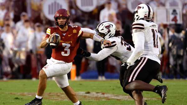 AMES, IA - NOVEMBER 02: Quarterback Rocco Becht #3 of the Iowa State Cyclones, scrambles under pressure from linebacker Harvey Dyson III #33, and linebacker Charles Esters III #11 of the Texas Tech Red Raiders in the second half of play at Jack Trice Stadium on November 2, 2024, in Ames, Iowa. The Texas Tech Red Raiders won 23-22 over the Iowa State Cyclones. (Photo by David Purdy/Getty Images)