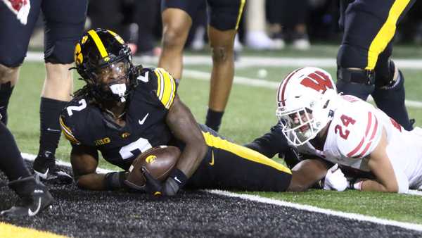 IOWA CITY, IOWA- NOVEMBER 02:  Running back Kaleb Johnson #2 of the Iowa Hawkeyes scores a touchdown during the second half in front of safety Hunter Wohler #24 of the Wisconsin Badgers, at Kinnick Stadium. on November 2, 2024 in Iowa City, Iowa.  (Photo by Matthew Holst/Getty Images)