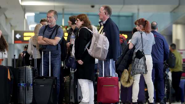 Travelers pass through the Miami International Airport on Dec. 20, 2024, as some of the year's busiest travel days occur during the holiday season in Miami, Florida.