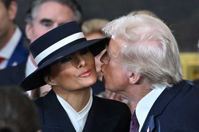 WASHINGTON, DC - JANUARY 20: U.S. President-elect Donald Trump kisses Melania Trump at his inauguration in the U.S. Capitol Rotunda on January 20, 2025 in Washington, DC. Donald Trump takes office for his second term as the 47th President of the United States. (Photo by Saul Loeb-Pool/Getty Images)