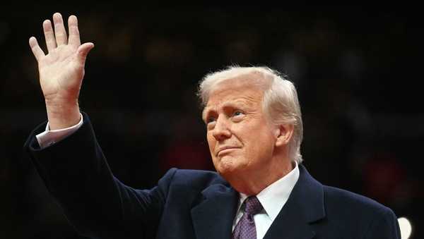 US President Donald Trump waves as he arrives at the inaugural parade inside Capitol One Arena in Washington, DC, on January 20, 2025. (Photo by Jim WATSON / AFP) (Photo by JIM WATSON/AFP via Getty Images)