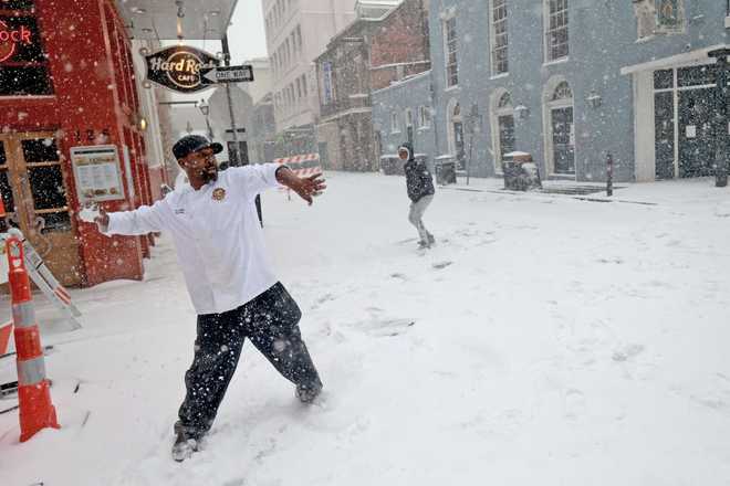 Sous chef Eric Walker engages in a snowball fight outside the Bourbon House Restaurant in the French Quarter on January 21, 2025 in New Orleans