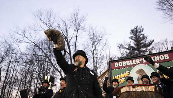 Groundhog Club handler A.J. Dereume holds Punxsutawney Phil, the weather prognosticating groundhog, during the 139th celebration of Groundhog Day on Gobbler's Knob in Punxsutawney, Pennsylvania on February 2, 2025.