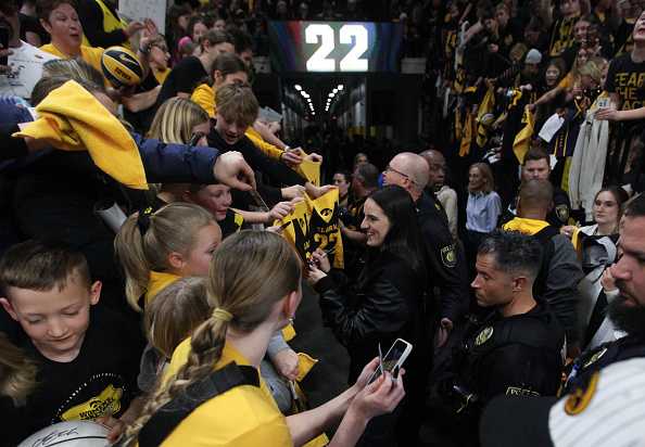 IOWA&#x20;CITY,&#x20;IOWA-&#x20;FEBRUARY&#x20;2&#x3A;&#x20;&#x20;Former&#x20;Iowa&#x20;Hawkeye&#x20;guard&#x20;and&#x20;current&#x20;Indiana&#x20;Fever&#x20;guard&#x20;Caitlin&#x20;Clark&#x20;&#x23;22&#x20;signs&#x20;autographs&#x20;for&#x20;fans&#x20;during&#x20;a&#x20;ceremony&#x20;to&#x20;retire&#x20;her&#x20;&#x23;22&#x20;following&#x20;the&#x20;match-up&#x20;against&#x20;the&#x20;USC&#x20;Trojans,&#x20;at&#x20;Carver-Hawkeye&#x20;Arena&#x20;on&#x20;February&#x20;2,&#x20;2025&#x20;&#x20;in&#x20;Iowa&#x20;City,&#x20;Iowa.&#x20;&#x20;&#x28;Photo&#x20;by&#x20;Matthew&#x20;Holst&#x2F;Getty&#x20;Images&#x29;