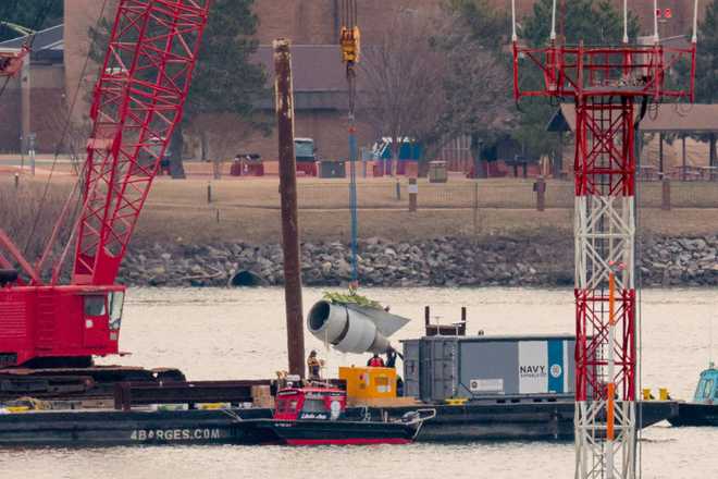 ARLINGTON, VIRGINIA - FEBRUARY 03: A crane lifts a jet engine out of the Potomac River during recovery efforts after the American Airlines crash on February 03, 2025 in Arlington, Virginia. An American Airlines flight from Wichita, Kansas collided midair with a military Black Hawk helicopter while on approach to Ronald Reagan Washington National Airport on January 29, 2025 outside of Washington, DC. According to reports, there were no survivors among the 67 people onboard both aircraft. (Photo by Chip Somodevilla/Getty Images)