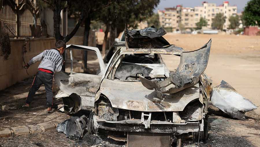 A boy checks a destroyed vehicle in Ashrafiyat Sahnaya near Damascus on May 1, 2025. Syrian Druze spiritual leader Sheikh Hikmat al-Hijri on May 1, condemned what he called a &quot;genocidal campaign&quot; against his people, after two days of deadly sectarian clashes. (Photo by OMAR HAJ KADOUR / AFP) (Photo by OMAR HAJ KADOUR/AFP via Getty Images)          