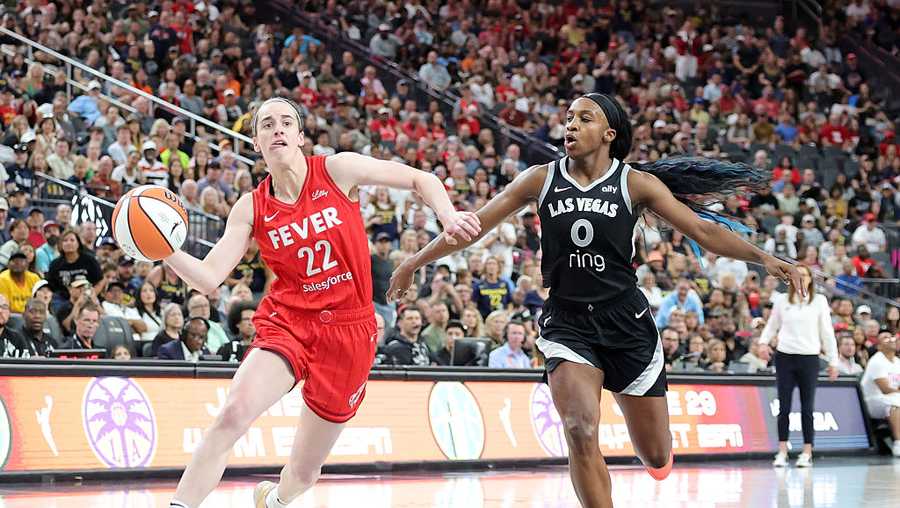 LAS VEGAS, NEVADA - JUNE 22: Caitlin Clark #22 of the Indiana Fever drives against Jackie Young #0 of the Las Vegas Aces in the fourth quarter of their game at T-Mobile Arena on June 22, 2025 in Las Vegas, Nevada. The Aces defeated the Fever 89-81. NOTE TO USER: User expressly acknowledges and agrees that, by downloading and or using this photograph, User is consenting to the terms and conditions of the Getty Images License Agreement. (Photo by Ethan Miller/Getty Images)