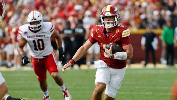 AMES, IA - AUGUST 30: Quarterback Rocco Becht #3 of the Iowa State Cyclones scrambles for yards as defensive lineman Caden Crawford #10 of the South Dakota Coyotes defends in the first half of play at Jack Trice Stadium on August 30, 2025, in Ames, Iowa. (Photo by David Purdy/Getty Images)