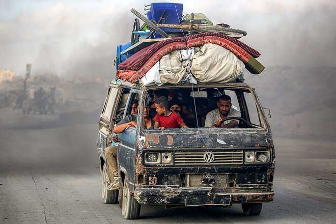 TOPSHOT&#x20;-&#x20;People&#x20;ride&#x20;a&#x20;microbus&#x20;carrying&#x20;their&#x20;belongings&#x20;as&#x20;they&#x20;evacuate&#x20;southbound&#x20;from&#x20;Gaza&#x20;City&#x20;on&#x20;September&#x20;2,&#x20;2025.&#x20;Israel&#x20;intensified&#x20;its&#x20;military&#x20;build-up&#x20;on&#x20;September&#x20;2&#x20;as&#x20;reservists&#x20;began&#x20;responding&#x20;to&#x20;call-up&#x20;orders&#x20;ahead&#x20;of&#x20;a&#x20;planned&#x20;offensive&#x20;on&#x20;Gaza&#x20;City,&#x20;despite&#x20;mounting&#x20;pressure&#x20;at&#x20;home&#x20;and&#x20;abroad&#x20;to&#x20;end&#x20;the&#x20;nearly&#x20;two-year&#x20;campaign&#x20;in&#x20;the&#x20;Palestinian&#x20;territory.&#x20;&#x28;Photo&#x20;by&#x20;Eyad&#x20;BABA&#x20;&#x2F;&#x20;AFP&#x29;&#x20;&#x28;Photo&#x20;by&#x20;EYAD&#x20;BABA&#x2F;AFP&#x20;via&#x20;Getty&#x20;Images&#x29;&#x20;&#x20;&#x20;&#x20;&#x20;&#x20;&#x20;&#x20;&#x20;&#x20;