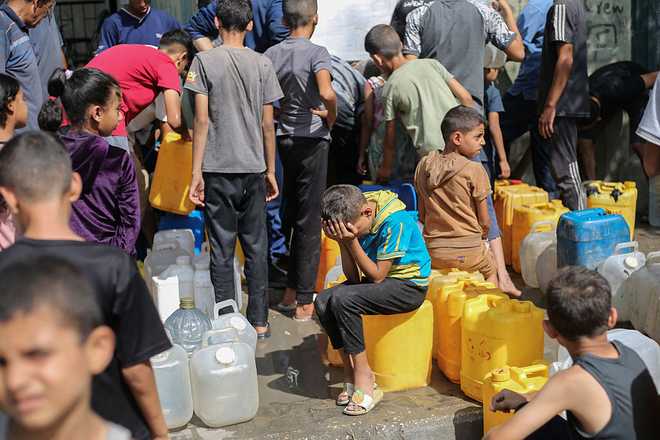 Palestinian&#x20;children&#x20;sit&#x20;on&#x20;their&#x20;containers&#x20;as&#x20;they&#x20;queue&#x20;for&#x20;water&#x20;at&#x20;a&#x20;charity&#x20;distribution&#x20;point&#x20;in&#x20;the&#x20;Nuseirat&#x20;refugee&#x20;camp&#x20;in&#x20;the&#x20;Israel-besieged&#x20;Gaza&#x20;Strip&#x20;on&#x20;September&#x20;4,&#x20;2025,&#x20;where&#x20;the&#x20;UN&#x20;has&#x20;declared&#x20;famine&#x20;after&#x20;nearly&#x20;two&#x20;years&#x20;of&#x20;war.&#x20;&#x28;Photo&#x20;by&#x20;Eyad&#x20;BABA&#x20;&#x2F;&#x20;AFP&#x29;&#x20;&#x28;Photo&#x20;by&#x20;EYAD&#x20;BABA&#x2F;AFP&#x20;via&#x20;Getty&#x20;Images&#x29;&#x20;&#x20;&#x20;&#x20;&#x20;&#x20;&#x20;&#x20;&#x20;&#x20;