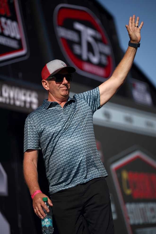 DARLINGTON, SOUTH CAROLINA - AUGUST 31: Former NASCAR Cup Series driver, Greg Biffle waves to fans as he walks onstage during pre-race ceremonies prior to the NASCAR Cup Series Cook Out Southern 500 at Darlington Raceway on August 31, 2025 in Darlington, South Carolina. (Photo by Jared C. Tilton/Getty Images)