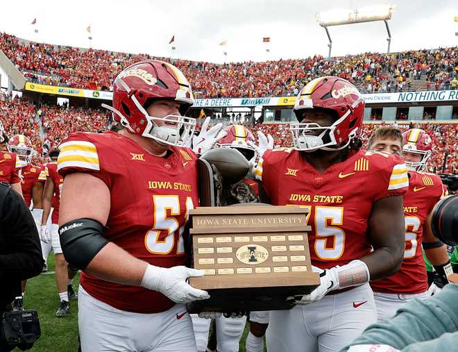 AMES,&#x20;IA&#x20;-&#x20;SEPTEMBER&#x20;6&#x3A;&#x20;Offensive&#x20;lineman&#x20;Brendan&#x20;Black&#x20;&#x23;51&#x20;of&#x20;the&#x20;Iowa&#x20;State&#x20;Cyclones&#x20;and&#x20;teammate&#x20;offensive&#x20;lineman&#x20;James&#x20;Neal&#x20;III&#x20;&#x23;75&#x20;of&#x20;the&#x20;Iowa&#x20;State&#x20;Cyclones&#x20;carry&#x20;the&#x20;Cy-Hawk&#x20;Series&#x20;trophy&#x20;and&#x20;celebate&#x20;after&#x20;defeating&#x20;the&#x20;Iowa&#x20;Hawkeyes&#x20;16-13&#x20;at&#x20;Jack&#x20;Trice&#x20;Stadium&#x20;on&#x20;September&#x20;6,&#x20;2025,&#x20;in&#x20;Ames,&#x20;Iowa.&#x20;The&#x20;Iowa&#x20;State&#x20;Cyclones&#x20;won&#x20;16-13&#x20;over&#x20;the&#x20;Iowa&#x20;Hawkeyes.&#x20;&#x28;Photo&#x20;by&#x20;David&#x20;Purdy&#x2F;Getty&#x20;Images&#x29;