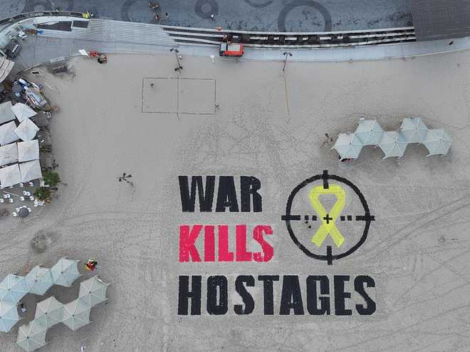 TEL&#x20;AVIV,&#x20;ISRAEL&#x20;-&#x20;SEPTEMBER&#x20;17&#x3A;&#x20;An&#x20;aerial&#x20;view&#x20;of&#x20;the&#x20;phrase&#x20;&amp;quot&#x3B;War&#x20;kills&#x20;hostages&amp;quot&#x3B;&#x20;written&#x20;in&#x20;large&#x20;letters&#x20;in&#x20;the&#x20;sand,&#x20;emphasizing&#x20;that&#x20;the&#x20;attacks&#x20;on&#x20;Gaza&#x20;are&#x20;endangering&#x20;the&#x20;lives&#x20;of&#x20;the&#x20;hostages,&#x20;as&#x20;a&#x20;group&#x20;of&#x20;activists&#x20;in&#x20;Israel&#x20;staged&#x20;a&#x20;protest&#x20;near&#x20;the&#x20;U.S.&#x20;Embassy&#x20;in&#x20;Tel&#x20;Aviv&#x20;on&#x20;September&#x20;17,&#x20;2025.&#x20;&#x28;Photo&#x20;by&#x20;Stringer&#x2F;Anadolu&#x20;via&#x20;Getty&#x20;Images&#x29;
