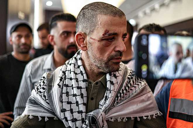 One&#x20;of&#x20;the&#x20;Palestinian&#x20;prisoners,&#x20;who&#x20;was&#x20;released&#x20;in&#x20;a&#x20;prisoner-hostage&#x20;swap&#x20;and&#x20;ceasefire&#x20;deal&#x20;between&#x20;Israel&#x20;and&#x20;Hamas,&#x20;looks&#x20;on&#x20;upon&#x20;arrival&#x20;by&#x20;bus&#x20;at&#x20;Ramallah&#x20;Cultural&#x20;Centre&#x20;in&#x20;Ramallah&#x20;in&#x20;the&#x20;occupied&#x20;West&#x20;Bank,&#x20;on&#x20;October&#x20;13,&#x20;2025,&#x20;coming&#x20;from&#x20;Ofer&#x20;military&#x20;prison&#x20;in&#x20;the&#x20;Israel-occupied&#x20;Palestinian&#x20;territories.