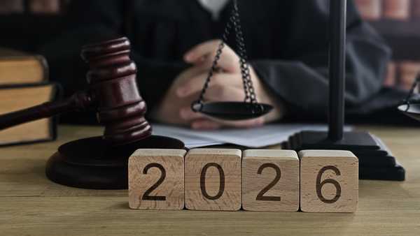 Judge at a courtroom with gavel and scales of justice, looking ahead towards the year 2026 during a legal proceeding