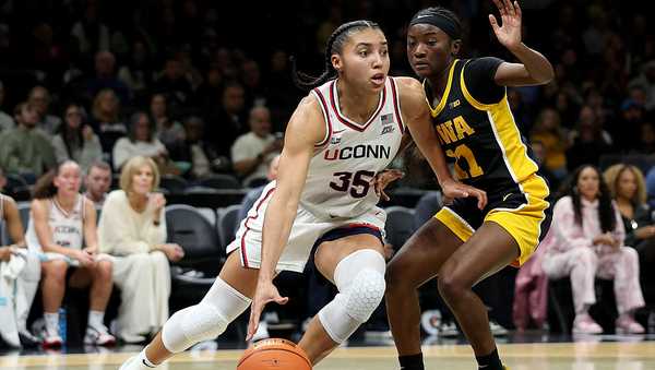 NEW YORK, NEW YORK - DECEMBER 20: Azzi Fudd #35 of the UConn Huskies heads for the net as Chazadi Wright #11 of the Iowa Hawkeyes defends during the 2025 Women's Champions Classic at Barclays Center on December 20, 2025 in the Brooklyn borough of New York City. (Photo by Elsa/Getty Images)