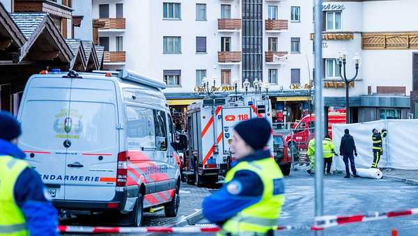 Police officers stand guard at the site of an explosion that ripped through the bar Le Constellation in Crans-Montana on January 1, 2026.