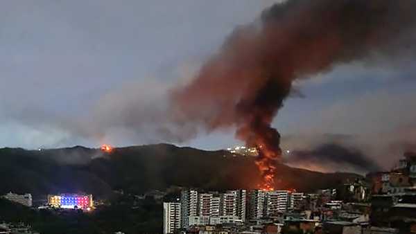 Fire at Fuerte Tiuna, Venezuela's largest military complex, is seen from a distance after a series of explosions in Caracas on January 3, 2026.