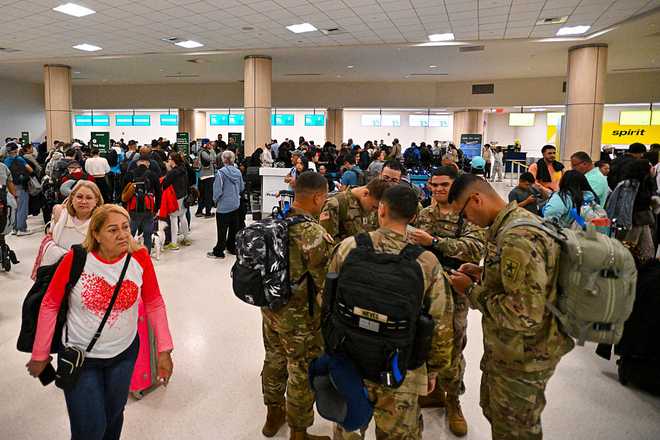 CORRECTION / Passengers wait at Luis Munoz Marin International Airport as all flights are cancelled following US military action in Venezuela, on January 3, 2026,  in Carolina, Puerto Rico. President Donald Trump said Saturday that US forces had captured Venezuelan leader Nicolas Maduro after launching a "large scale strike" on the South American country. "The United States of America has successfully carried out a large scale strike against Venezuela and its leader, President Nicolas Maduro, who has been, along with his wife, captured and flown out of the Country," Trump said on Truth Social. (Photo by Miguel J. Rodriguez Carrillo / AFP via Getty Images) / "The erroneous mention[s] appearing in the metadata of this photo by Miguel J. Rodriguez Carrillo has been modified in AFP systems in the following manner: [Luis Munoz Marin International Airport] instead of [José Aponte De la Torre Airport]. Please immediately remove the erroneous mention[s] from all your online services and delete it (them) from your servers. If you have been authorized by AFP to distribute it (them) to third parties, please ensure that the same actions are carried out by them. Failure to promptly comply with these instructions will entail liability on your part for any continued or post notification usage. Therefore we thank you very much for all your attention and prompt action. We are sorry for the inconvenience this notification may cause and remain at your disposal for any further information you may require."