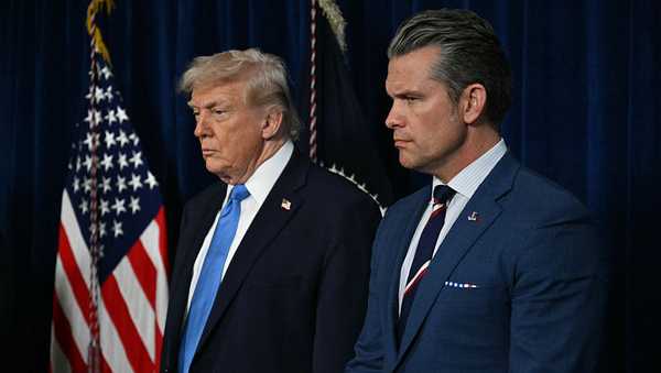 (L/R) US President Donald Trump and US Secretary of Defense Pete Hegseth look on as  Chairman of the Joint Chiefs of Staff General Dan Caine (out of frame) speaks to the press following US military actions in Venezuela, at Trump's Mar-a-Lago residence in Palm Beach, Florida, on January 3, 2026. President Trump said Saturday that US forces had captured Venezuelan leader Nicolas Maduro after launching a "large scale strike" on the South American country. (Photo by Jim WATSON / AFP via Getty Images)