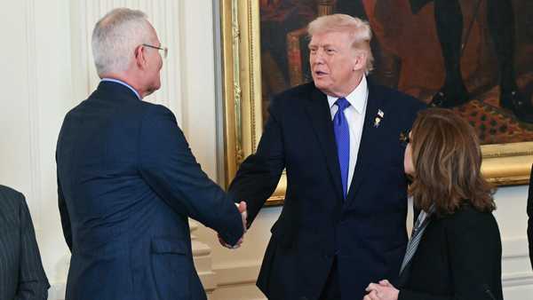 US President Donald Trump shakes hands with ExxonMobil CEO Darren Woods, during a meeting with US oil companies executives in the East Room of the White House in Washington, DC on January 9, 2026. President Trump is aiming to convince oil executives to support his plans in Venezuela, a country whose energy resources he says he expects to control for years to come. US forces seized Venezuelan president Nicolas Maduro in a sweeping military operation on January 3, with Trump making no secret that control of Venezuela's oil was at the heart of his actions. (Photo by SAUL LOEB / AFP via Getty Images)