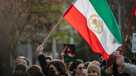 A woman holds a placard demanding freedom for Iran during a