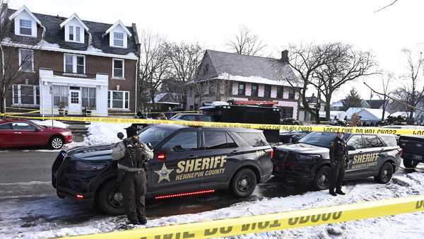 MINNEAPOLIS, MINNESOTA - JANUARY 07: Members of the Hennepin County Sheriff's Office look on as people gather near the scene of a suspected shooting by an ICE agent during federal law enforcement operations on January 07, 2026 in Minneapolis, Minnesota. According to federal officials, the agent, 
