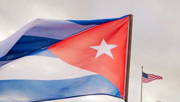A Cuban soldier waves a national flag as he takes part in the