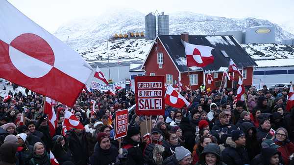 People hold Greenlandic flags and placards as they gather by the United States Consulate to march in protest against U.S. President Donald Trump and his announced intent to acquire Greenland on January 17, 2026 in Nuuk, Greenland.