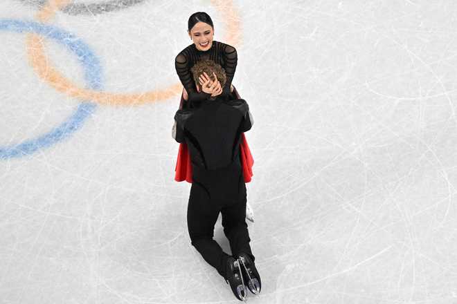USA's Madison Chock and USA's Evan Bates react after competing in the figure skating ice dance-free dance final during the Milano Cortina 2026 Winter Olympic Games at Milano Ice Skating Arena in Milan on February 11, 2026. (Photo by Antonin THUILLIER / AFP)