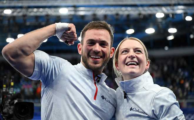 Korey Dropkin and Cory Thiesse of Team United States celebrate after winning the Curling Mixed Doubles semi-finals match between Team Italy and Team United States on day three of the Milano Cortina 2026 Winter Olympic games at Cortina Curling Olympic Stadium on February 09, 2026 in Cortina d'Ampezzo, Italy. (Photo by Mattia Ozbot/Getty Images)