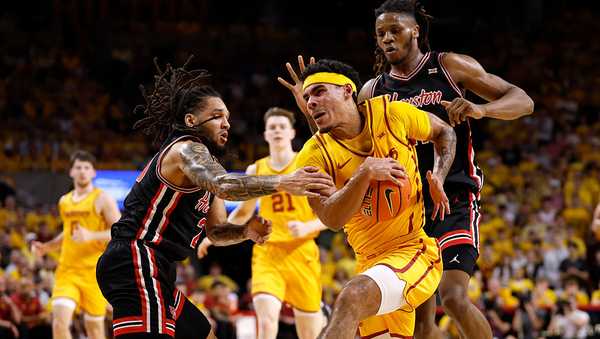 AMES, IA - FEBRUARY 16: Tamin Lipsey #3 of the Iowa State Cyclones drives the ball as Emanuel Sharp #21 of the Houston Cougars, and Joseph Tugler #11 of the Houston Cougars both defend in the first half of play at Hilton Coliseum on February 16, 2026 in Ames, Iowa. The Iowa State Cyclones won 70-67 over the Houston Cougars. (Photo by David K Purdy/Getty Images)