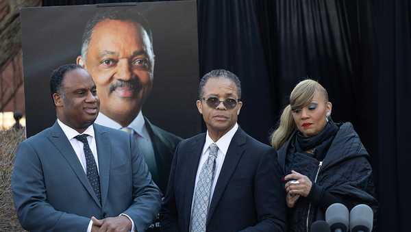 CHICAGO, ILLINOIS - FEBRUARY 18: Rep. Jonathan Jackson (D-IL) (L), his brother Jesse Jackson Jr. and sister Santita Jackson join their other siblings in speaking about their father outside their parents' home on February 18, 2026 in Chicago, Illinois. Jesse Jackson Sr. died early yesterday morning. (Photo by Scott Olson/Getty Images)