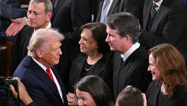 President Donald Trump shakes hands with Supreme Court Justice Amy Coney Barrett (R) as he arrives to deliver the State of the Union address in the House Chamber of the U.S. Capitol in Washington, D.C., on February 24, 2026.