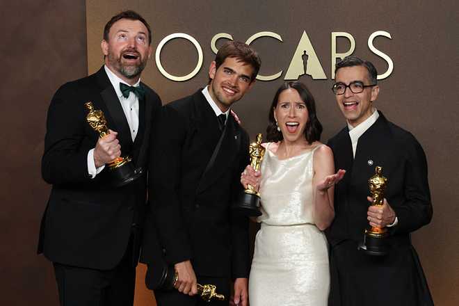 (L/R) After a tie in the category, US filmmakers Jack Piatt and Sam Davis hold the Oscar for best Best Live Action Short Film for &amp;quot;The Singers&amp;quot; alongside US filmmaker Alexandre Singh and US curator Natalie Musteata with their Oscar for best Best Live Action Short Film for &amp;quot;Two People Exchanging Saliva&amp;quot; in the press room during the 98th Annual Academy Awards at the Dolby Theatre in Hollywood, California on March 15, 2026. (Photo by VALERIE MACON / AFP via Getty Images)
