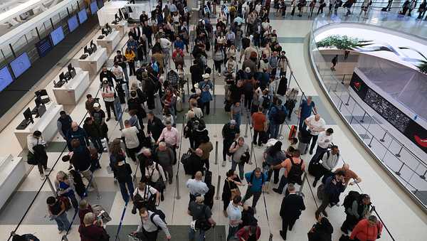 HOUSTON, TEXAS - MARCH 19: Travelers wait in line at Terminal E at George Bush International Airport on March 19, 2026 in Houston, Texas. Airports across the country continue to experience long lines during the federal shutdown affecting TSA. (Photo by Antranik Tavitian/Getty Images)
