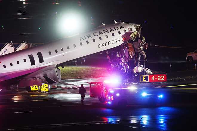 An Air Canada Express plane sits on the tarmac after it collided with a fire truck on the tarmac at LaGuardia Airport on March 23, 2026 in New York City.